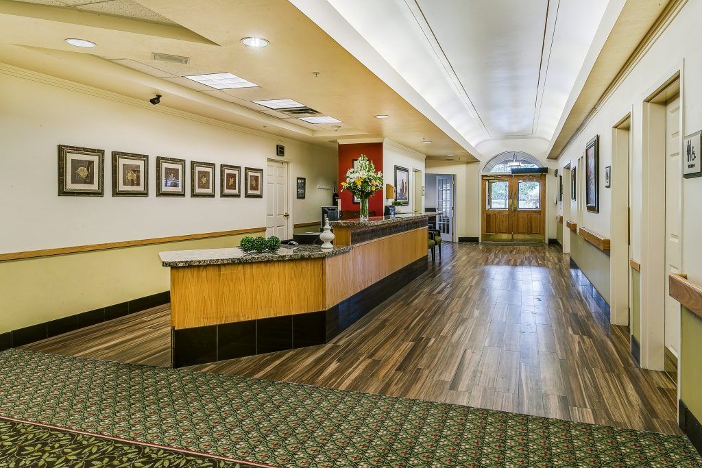 A modern lobby area with a reception desk and decorative elements.