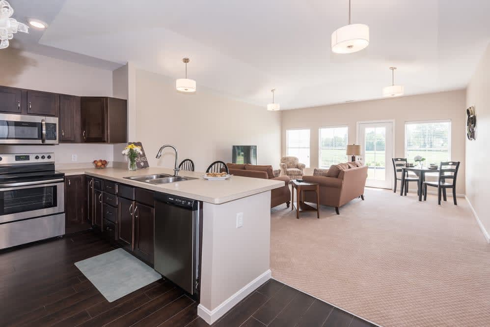 A modern open-concept kitchen and living room with ample natural light and stylish furnishings.