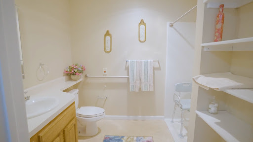A bright and tidy bathroom featuring a shower, towels neatly hung, and minimalist decor.