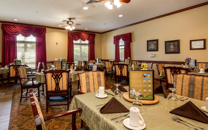 A cozy dining room with elegantly set tables, ready for guests.
