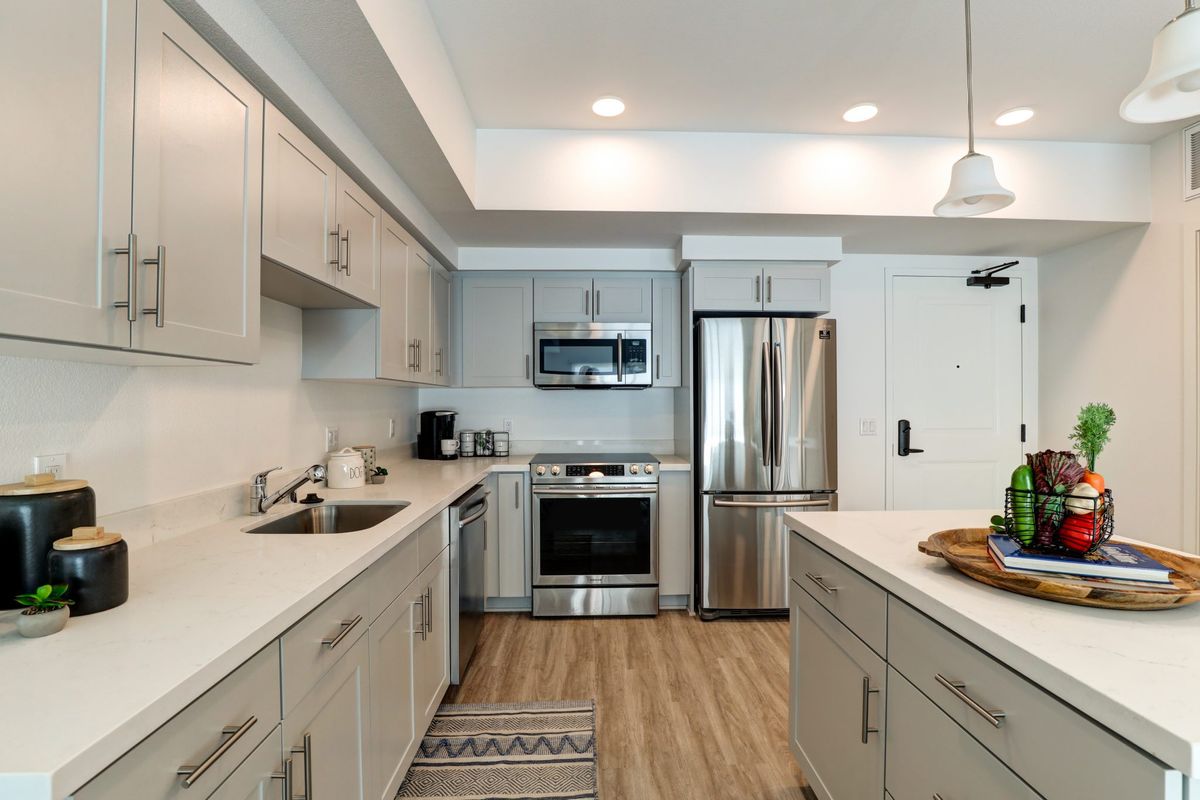 A modern kitchen with stainless steel appliances and sleek cabinetry.