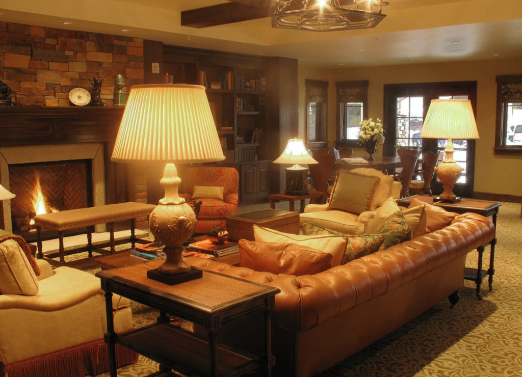 A cozy living room with warm lighting, featuring comfortable sofas and elegant lamps.