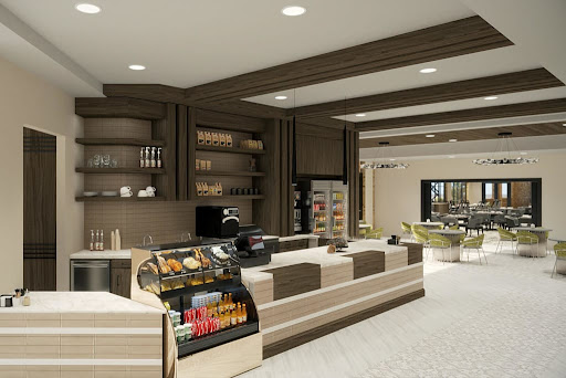 A modern caf interior featuring a sleek counter, display shelves, and seating area.