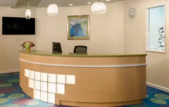 A modern reception desk with minimalistic design and ambient lighting.