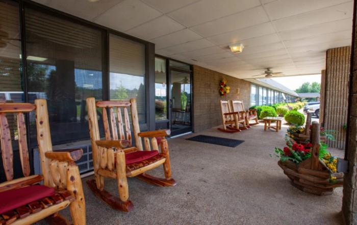 A cozy porch with wooden rocking chairs and potted plants, providing a relaxing outdoor space.