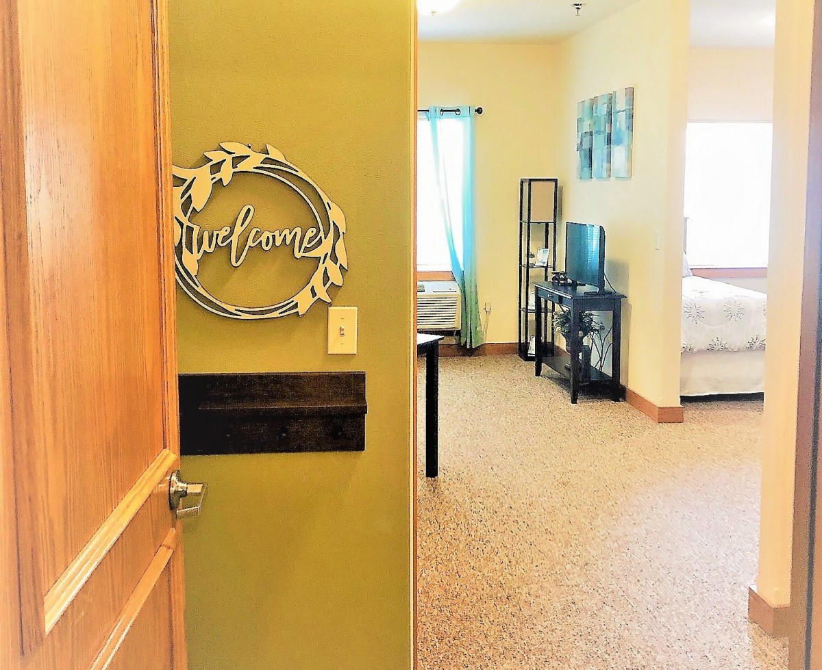 A welcoming entrance to a cozy living area, showcasing furniture and decor.
