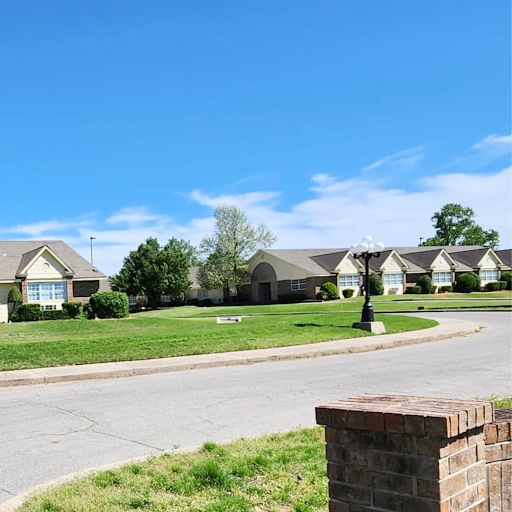 A serene view of a residential neighborhood under a clear blue sky.