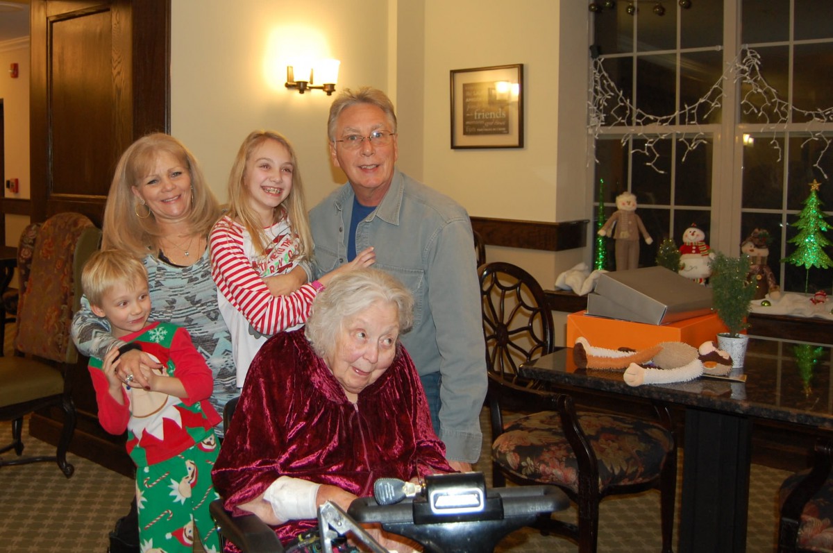 A joyful family gathering with multiple generations celebrating together indoors.