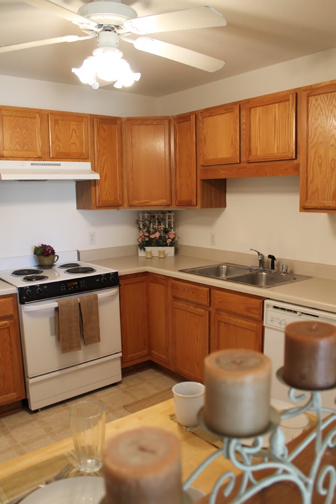A tidy kitchen with wooden cabinets and essential appliances.