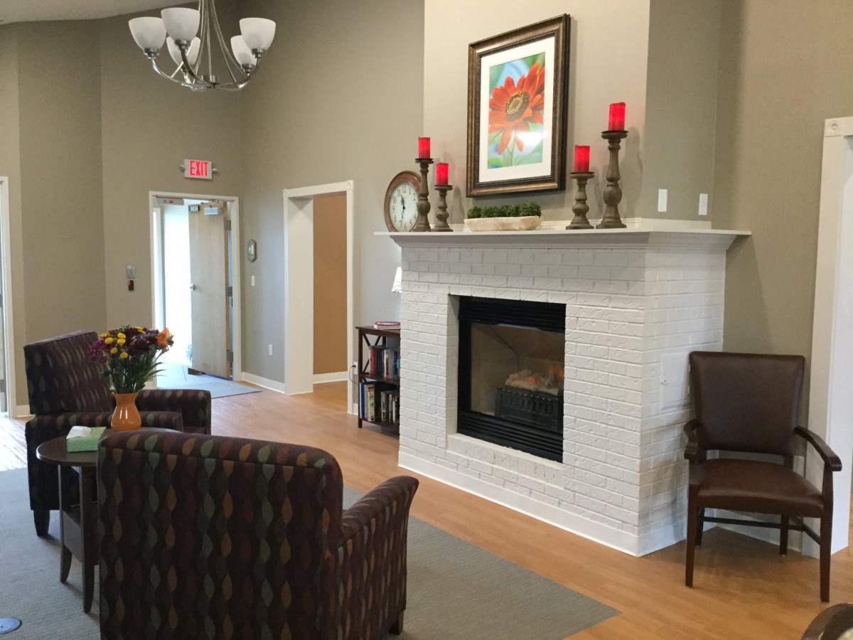 Cozy living room interior with a fireplace and comfy seating.
