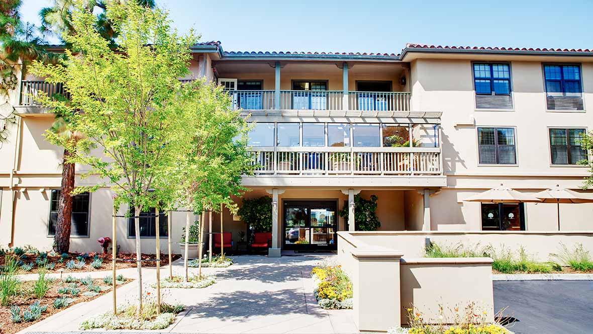 A modern building with a welcoming entrance and surrounding greenery.