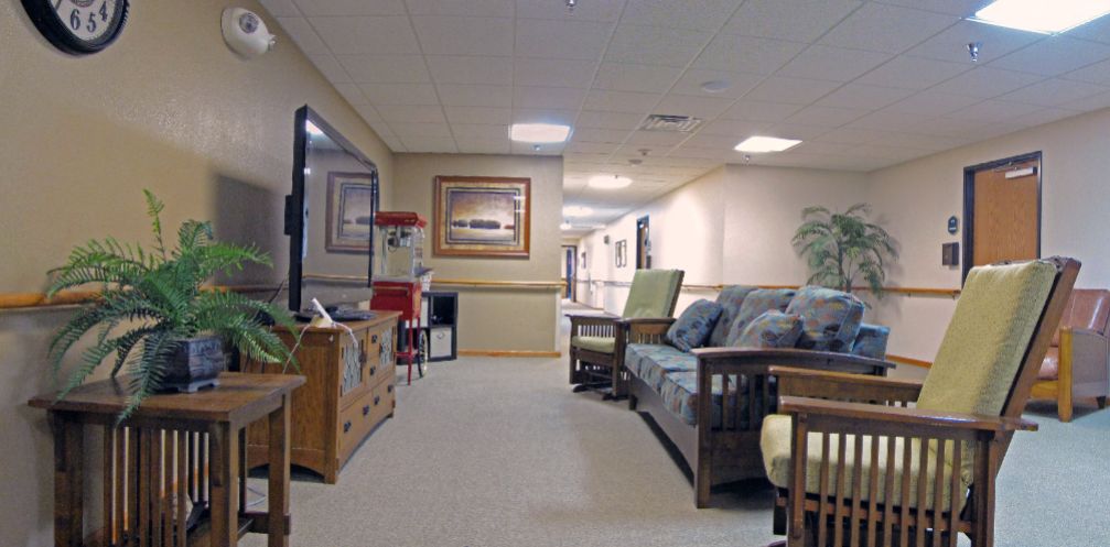 A cozy seating area in a hallway, featuring couches and decorative elements.
