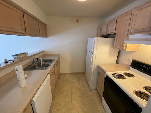 A compact and functional kitchen featuring essential appliances and cabinetry.