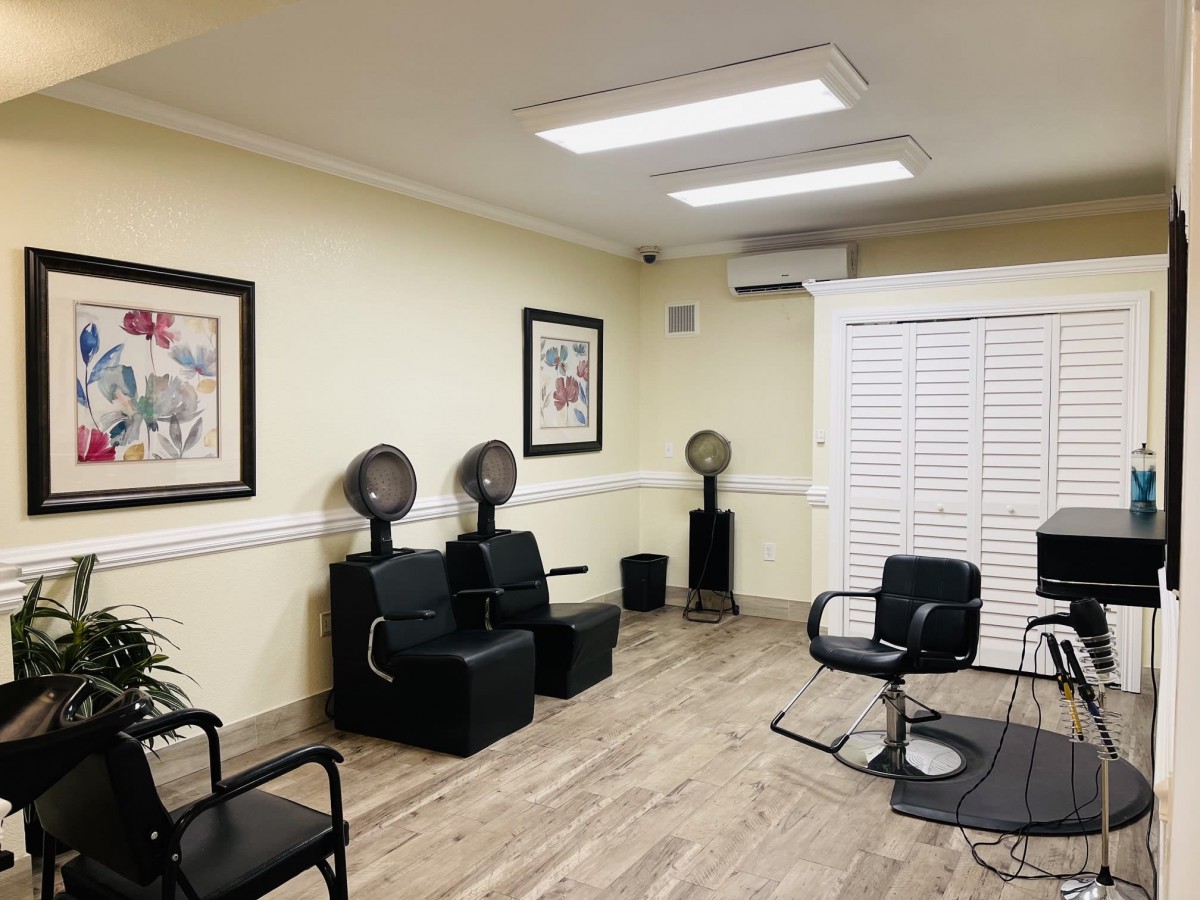 A salon interior with chairs and hair dryers arranged neatly.