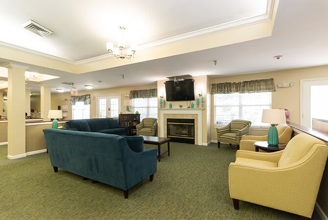 A cozy living room with comfortable seating, a fireplace, and a TV.