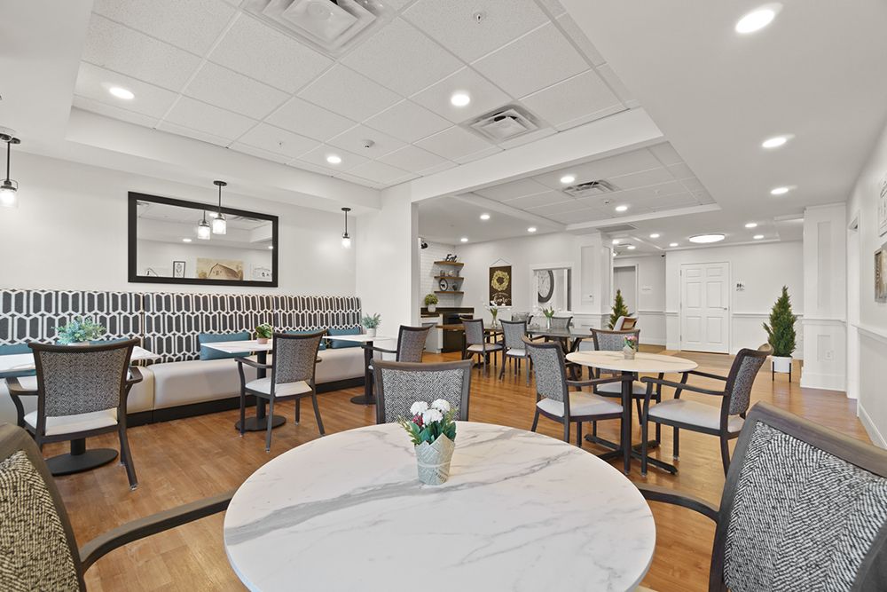 A modern dining area with neatly arranged tables and chairs, set in a stylishly decorated indoor space.