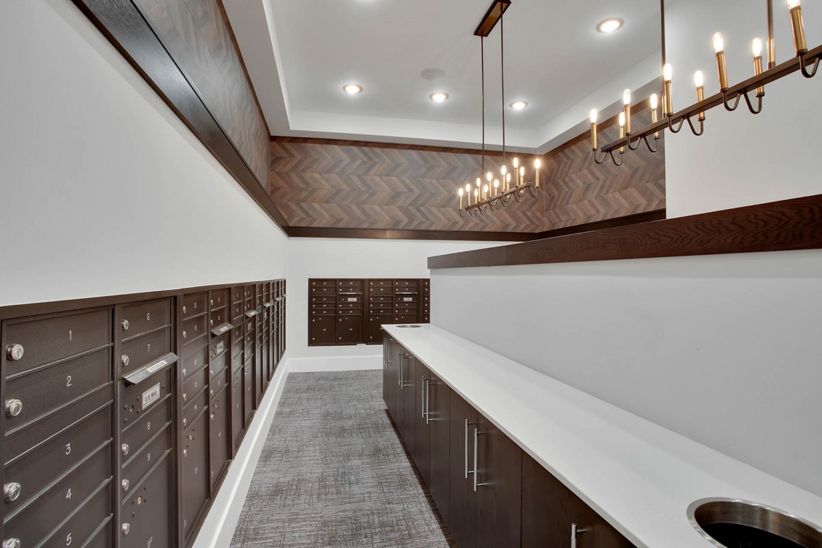 A modern mail room with sleek lockers and stylish lighting.