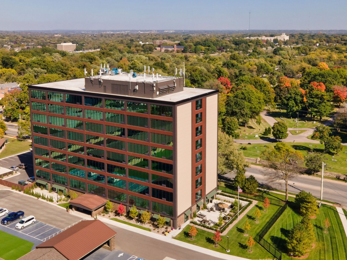 Aerial view of an office building surrounded by greenery.