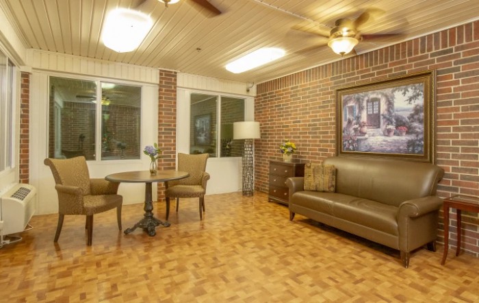 Cozy living room with brick walls and comfortable seating.