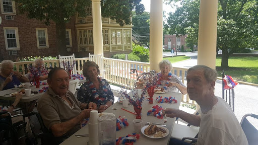 A joyful afternoon gathering on the porch with friends, celebrating togetherness in a festive atmosphere.