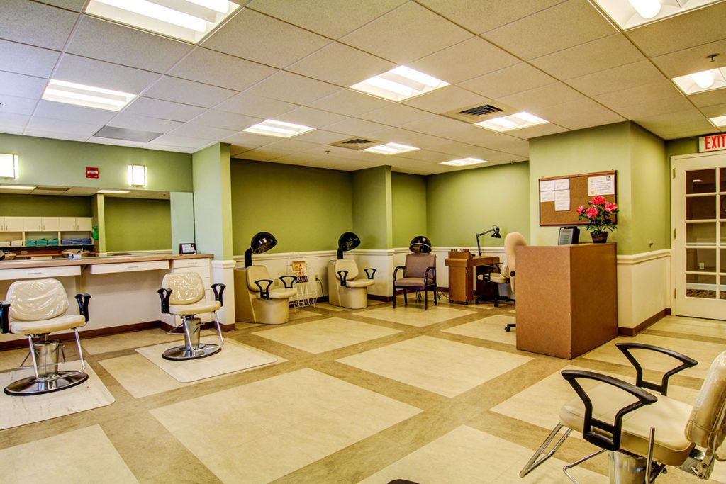A well-lit salon interior with multiple workstations and chairs.
