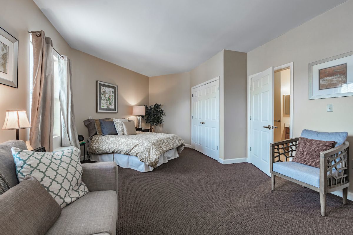 A spacious and elegantly designed bedroom with modern furnishings.