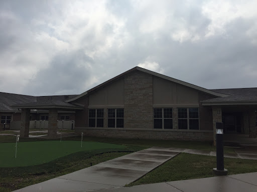 A modern residential building under a cloudy sky.
