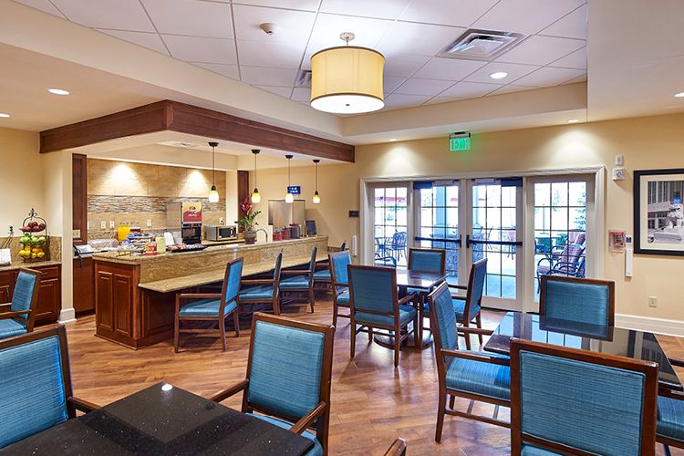 A contemporary dining area with stylish seating and warm lighting.