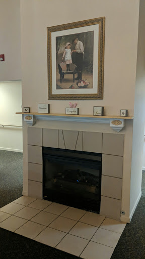 A cozy living room setup featuring a stylish fireplace and decorative mantel.