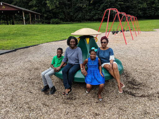 A joyful family enjoying a sunny day at the playground.