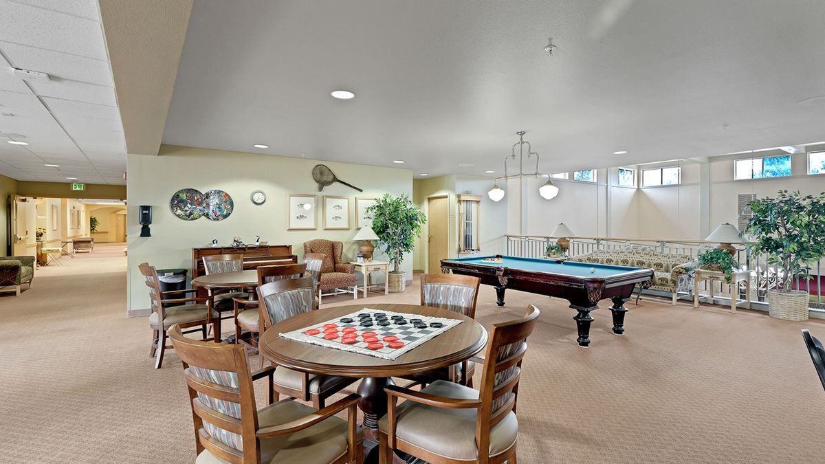 A cozy game room featuring a billiards table and board games.