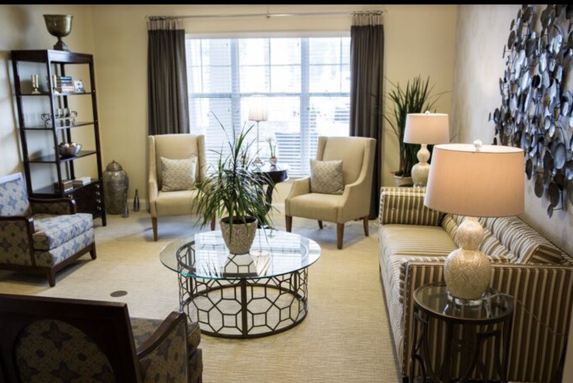 A well-decorated living room featuring comfortable seating, a stylish coffee table, and soft lighting.