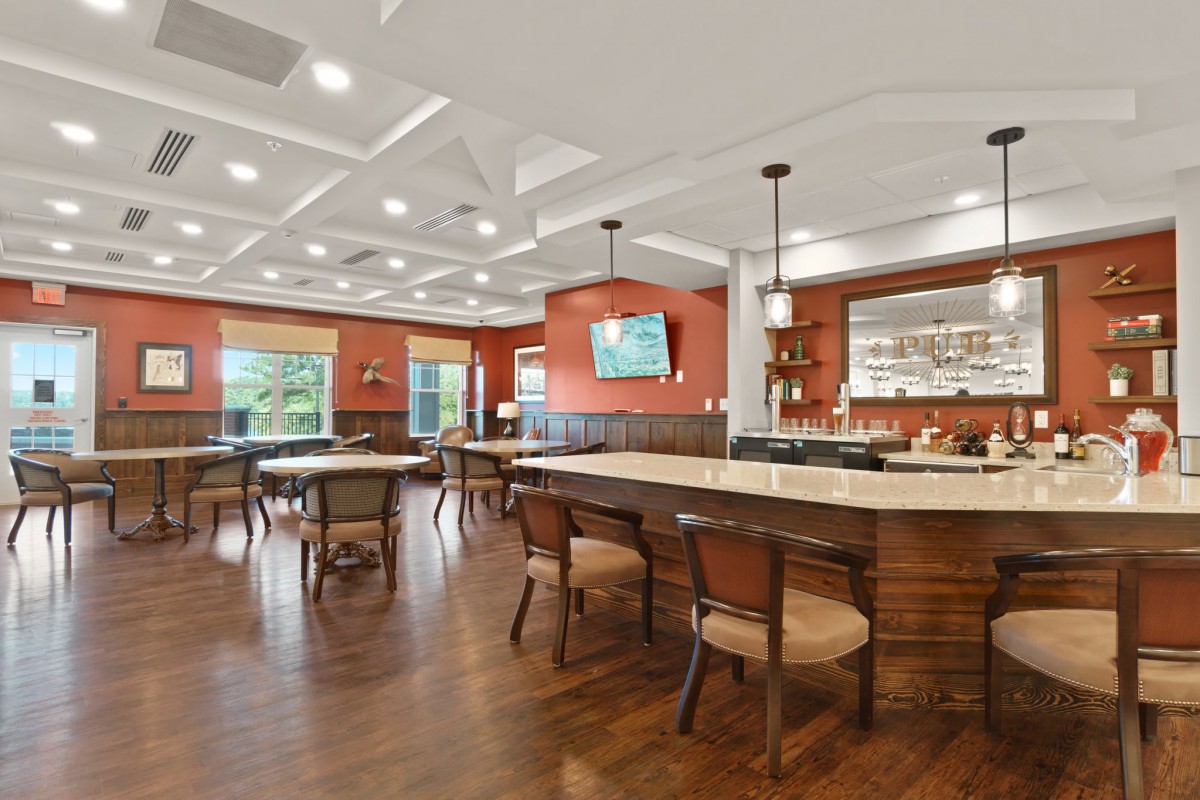 Modern restaurant interior with a bar and dining tables.