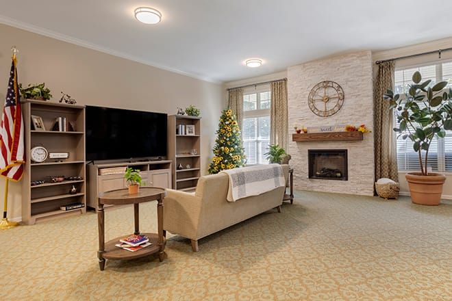 A modern living room featuring a cozy fireplace, large television, and elegant sofa with stylish decor.