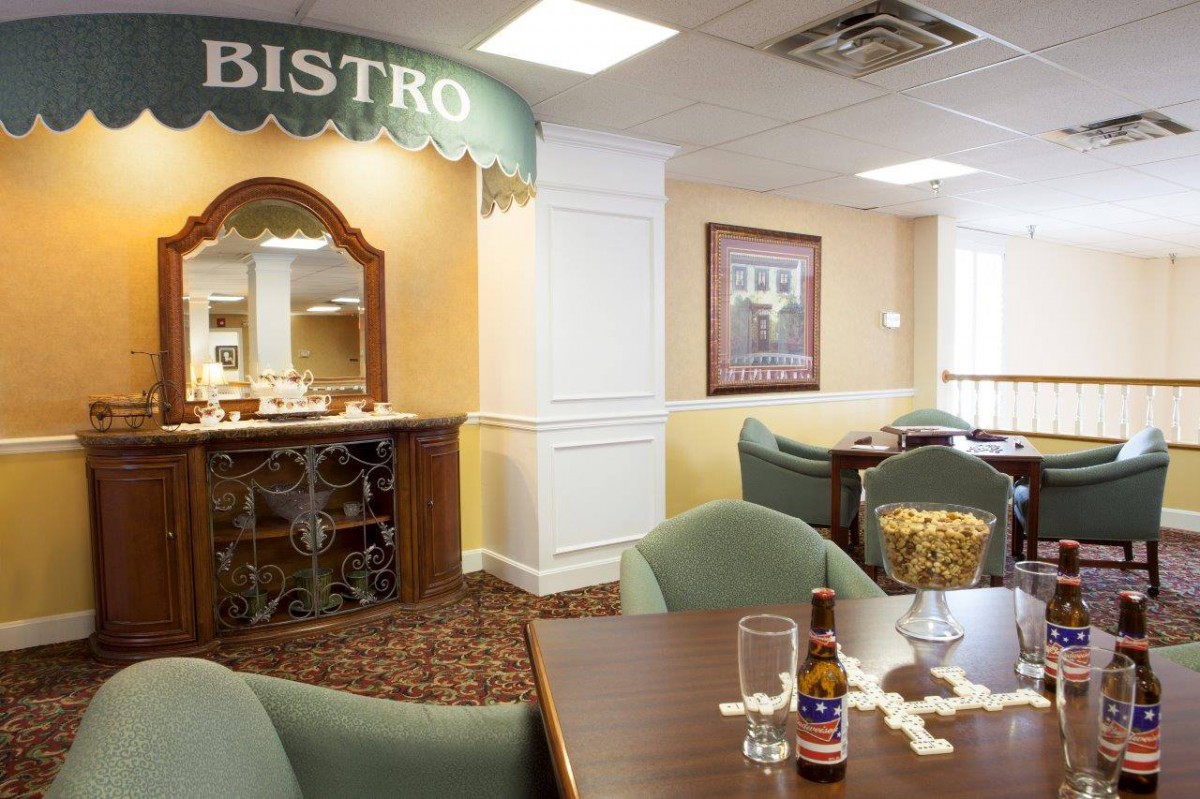 A cozy bistro dining area with tables and chairs arranged neatly, and a welcoming atmosphere.