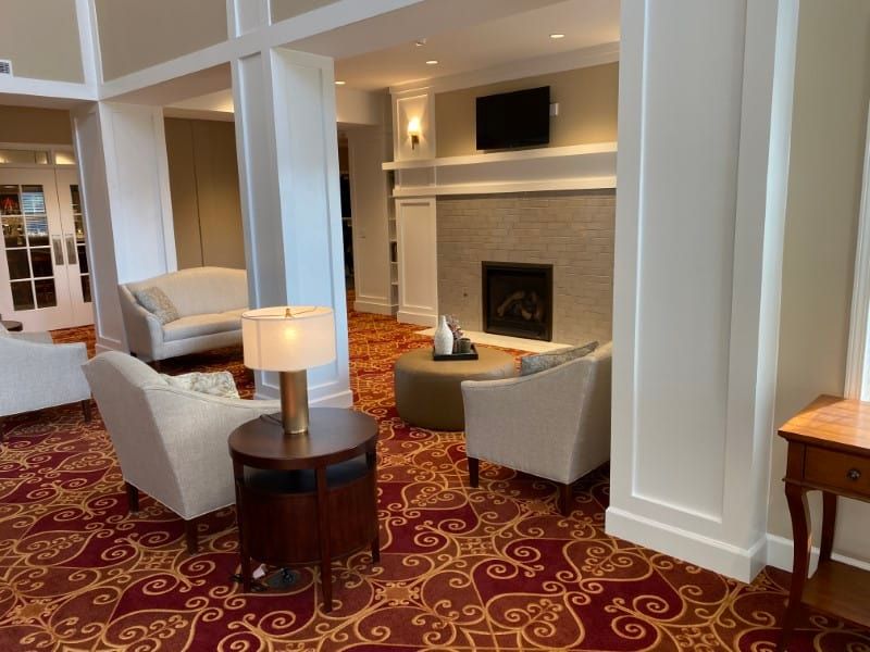 A cozy lounge area with comfortable seating around a fireplace.