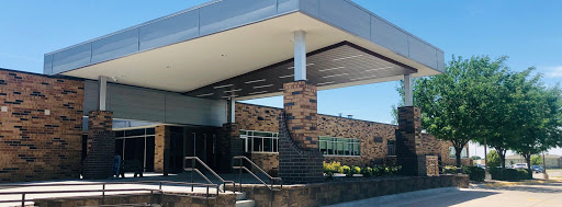 A modern building entrance featuring a combination of brick and contemporary design elements.