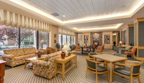 A warm and inviting lounge area with comfortable seating, tables, and ambient lighting.