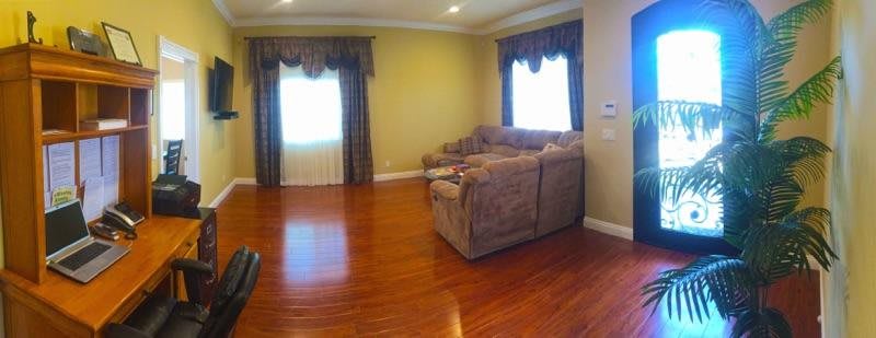 A cozy living room with a plush couch and hardwood flooring.