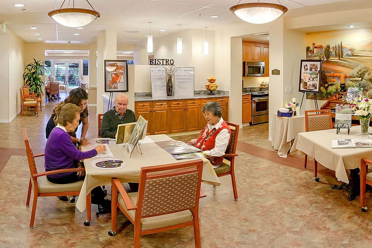 A cozy interior space where a group of seniors are gathered around a table in a communal area.