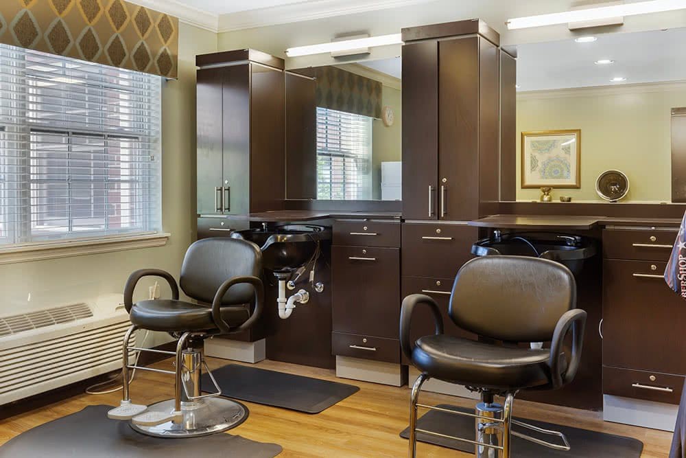 A modern hair salon with stylish chairs and mirrors.