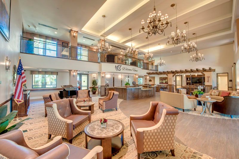 A spacious and elegantly designed lobby with comfortable seating and grand chandeliers.