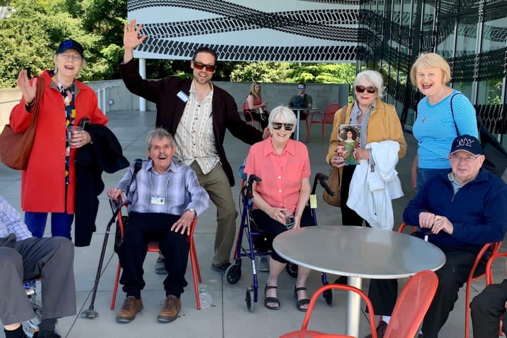 A group of people, including elderly individuals, enjoying an outdoor gathering.