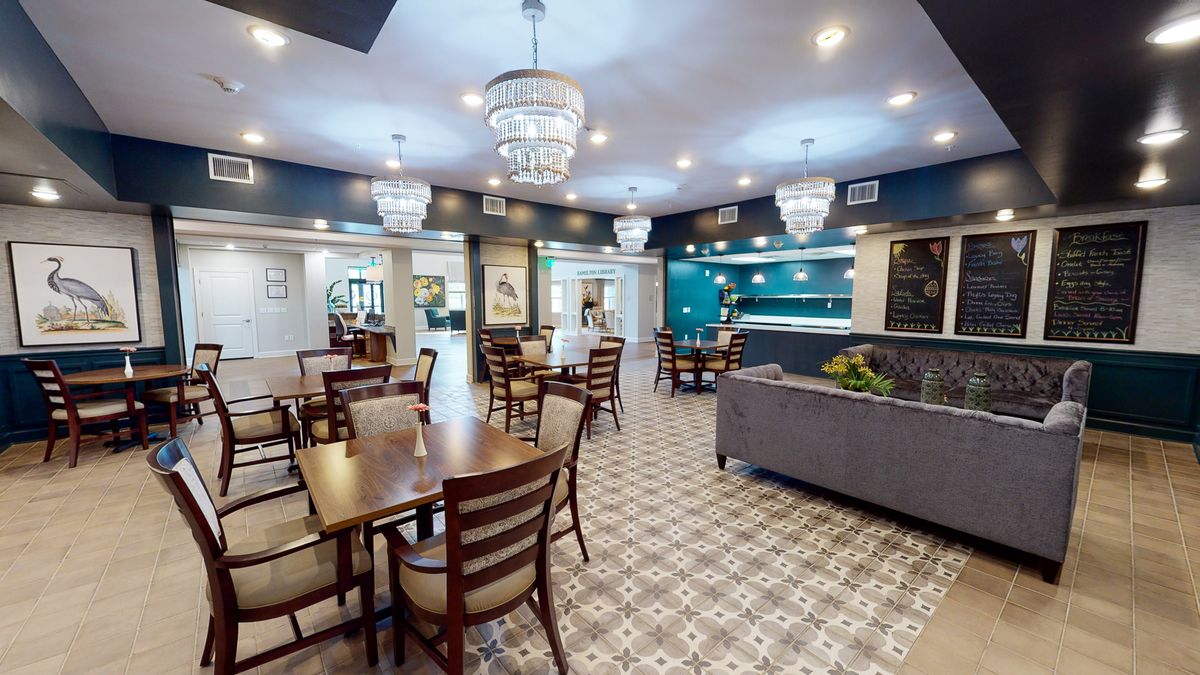 A modern dining area with elegant chandeliers and stylish furnishings.