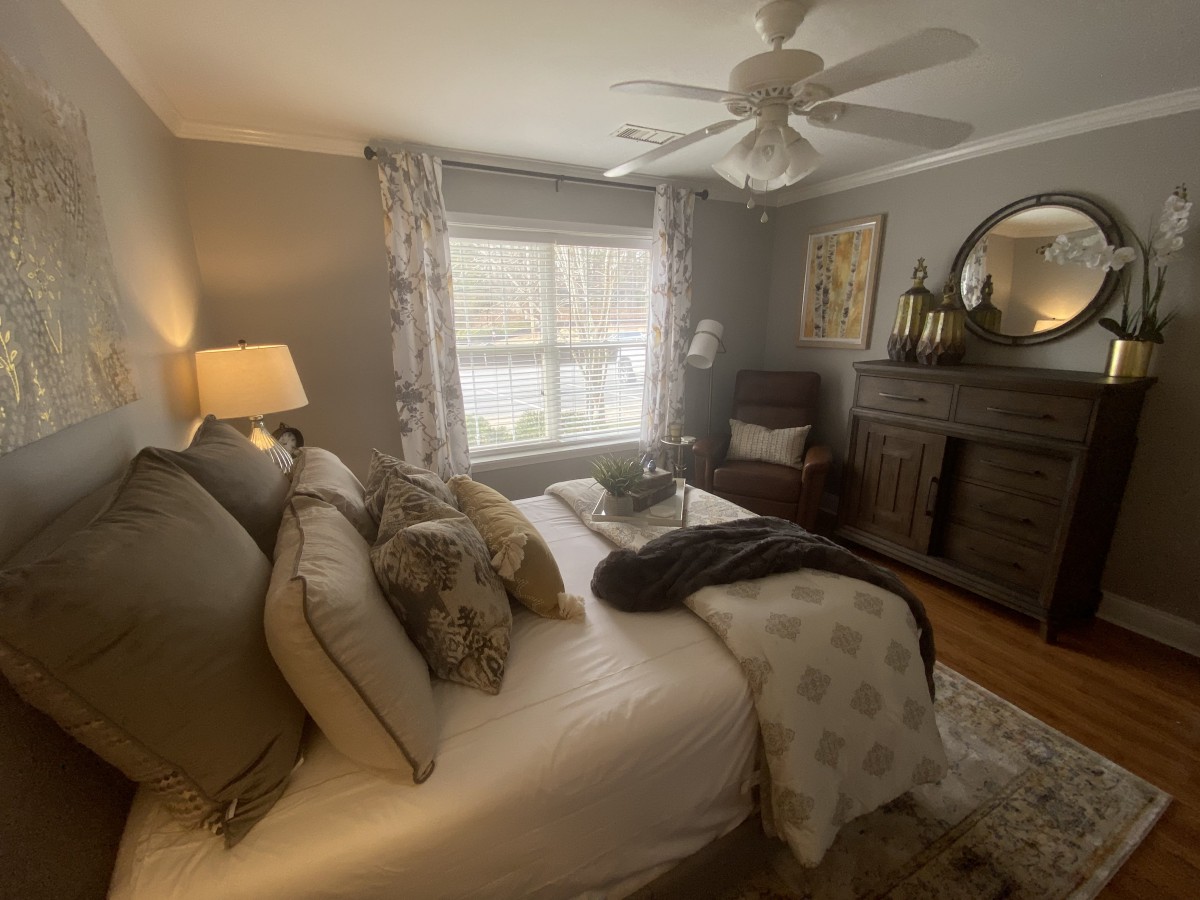 Cozy bedroom with elegant decor and natural lighting.