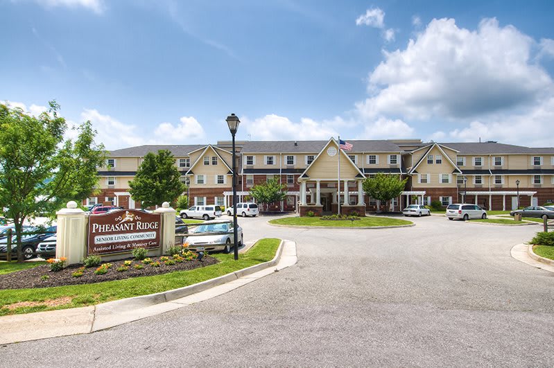 A well-maintained retirement home with a large entrance and neatly landscaped surroundings.