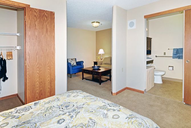 A cozy interior featuring a living area and adjoining bedroom.