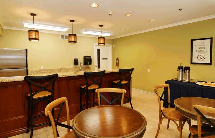 A cozy bar area with a wooden counter and comfortable seating.