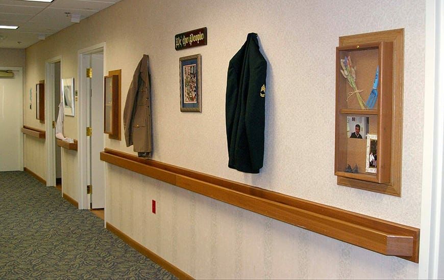 A hallway with jackets hanging on the wall and various decorative items.