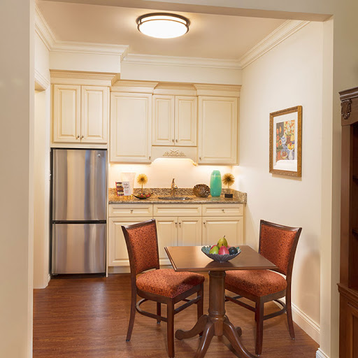 A cozy kitchen and dining area featuring wooden furniture and modern appliances.